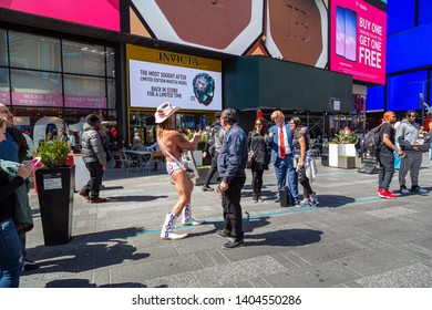 New York City, New York / USA United States - 04 07 2019: Naked Cowboy, Famous NYC Street Performer On A Times Square, Taking Picture Of President Donald Trump Artist. Editorial Use