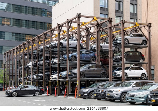 New York City, USA-May 2022; View of multi level
stacker parking system storing vehicles on platforms that can be
raised, lowered and shuffled around, allowing more cars to fit into
a smaller space