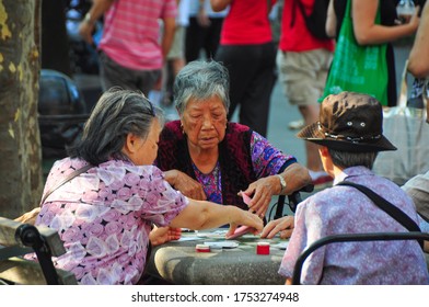 New York City, USA-Sept 2019; Close Up Of Elderly Chinese-American Women Playing A Card Game In One Of The Parks Of The City