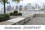 New York City waterfront skyline, Manhattan Midtown buildings, riverfront skyscrapers by East river water. Waterside cityscape, Gantry Plaza Park, Long Island, Queens, United States. Riverside bench.