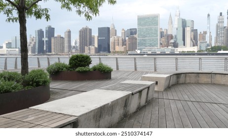 New York City waterfront skyline, Manhattan Midtown buildings, riverfront skyscrapers by East river water. Waterside cityscape, Gantry Plaza Park, Long Island, Queens, United States. Riverside bench. - Powered by Shutterstock