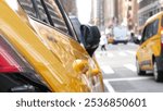 New York City. Yellow taxi car on Manhattan street. Taxi cab on Midtown Lexington avenue. Medallion taxicab rear view on Lex ave waiting for people or passengers on road. Urban scene in United States.