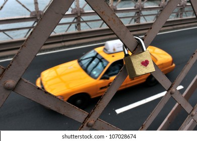 New York City yellow taxi cab passing by a padlock with a heart symbol locked on Brooklyn Bridge in Manhattan New York, USA. Valentines day love concept. No people. Copy space.