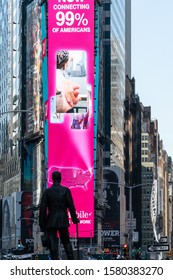 New York City/USA - September 2, 2019: Vertical View Of Iconic Statue And Pink Neon Advertising Billboard In Times Square.