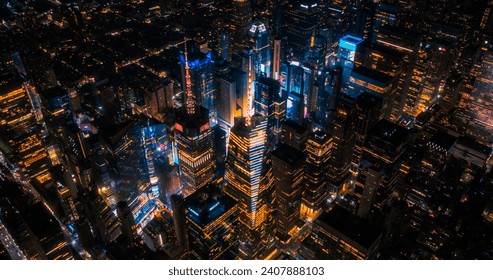 New York Concrete Jungle at Night. Aerial Photo from a Helicopter Tour Around the Center of the Big Apple. Scenes with Times Square District with Crowds of Tourists Enjoying Manhattan Nightlife - Powered by Shutterstock