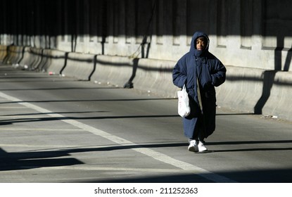 NEW YORK - DECEMBER 21:  A Pedestrian Walks Over The Queensborough Bridge (59th Street Bridge) During The Second Day Of The Transit Strike December 21, 2005 In New York City.