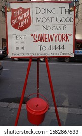 NEW YORK - DECEMBER 5, 2019: Salvation Army Sign And Red Kettle For Collections In Midtown Manhattan. This Christian Organization Is Known For Its Charity Work, Operating In 126 Countries