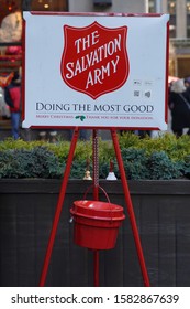 NEW YORK - DECEMBER 5, 2019: Salvation Army Sign And Red Kettle For Collections In Midtown Manhattan. This Christian Organization Is Known For Its Charity Work, Operating In 126 Countries