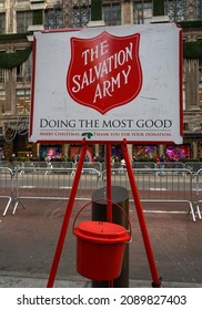 NEW YORK - DECEMBER 5, 2021: Salvation Army Sign And Red Kettle For Collections In Midtown Manhattan. This Christian Organization Is Known For Its Charity Work, Operating In 126 Countries