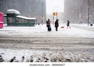 NEW YORK - FEB 9: Pedestrians Stand Near Astor Place As Snow Falls On February 9, 2017 In New York. Snowfall Totals Of Approximately Six Inches Fell In And Around NYC.