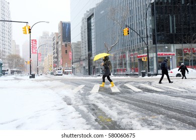 NEW YORK - FEB 9: Pedestrians Walk Along Astor Place As Snow Falls On February 9, 2017 In New York. Snowfall Totals Of Approximately Six Inches Fell In And Around NYC.