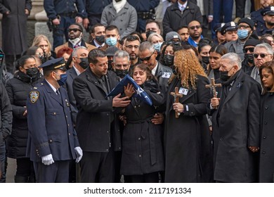 NEW YORK, NEW YORK - FEBRUARY 02, 2022: Amalia Mora, Mother Of Fallen Police Officer Wilbert Mora, Holds The Flag From His Casket During His Funeral At St. Patrick's Cathedral.