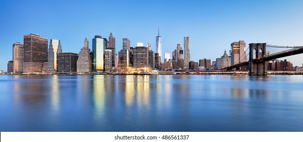 New York Financial District and the Lower Manhattan at dawn viewed from the Brooklyn Bridge Park.