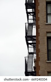 New York fire escape stairs isolated on gray sky