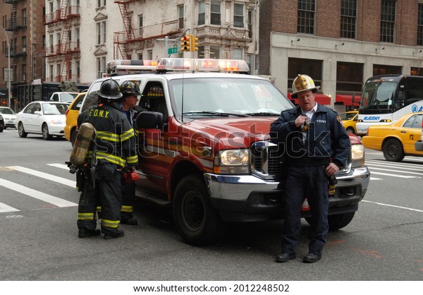 New York Firefighters on\
Scene at an Incident an Officer and Car.  New York City, USA,\
November 30 2010