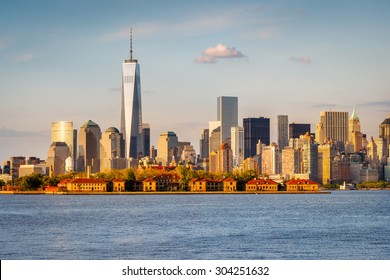 New York Harbor view of One World Trade Center and Downtown Manhattan with Financial District skyscrapers and Ellis Island. New York City.