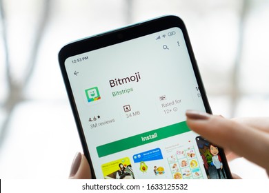 New York - January 20 2020 : girl holding a smartphone with Bitmoji app on the screen. Bitmoji is your own personal emoji. 