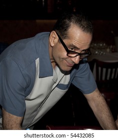 NEW YORK - JUNE 1: Tony Shalhoub Autographs Photo At Unveiling Painting To Honor Broadway Show Lend Me A Tenor At Tony's Di Napoli Restaurant In Manhattan On June 1, 2010 In New York City.