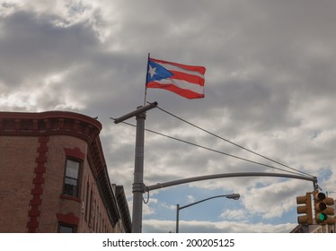 NEW YORK - JUNE 15: A Puerto Rican Flag Flying On A Light Pole On June 15th, 2014 In Bushwick, Brooklyn. Bushwick Is The Largest Hub Of Brooklyn's Hispanic-American Community. 