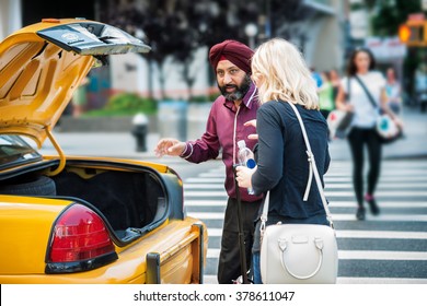 NEW YORK - JUNE 22: New York City Taxi Cab Driver Picking Up Passenger From The Street, June 22, 2015 New York City. USA.