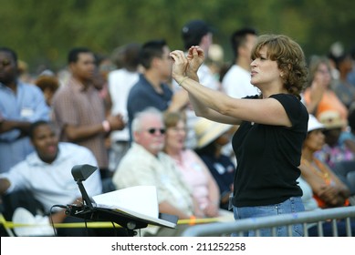 NEW YORK - JUNE 25:  A sign language interpreter gestures during the Greater New York Billy Graham Crusade in Flushing Meadow Corona Park June 25, 2005 in the Queens borough of New York City. 