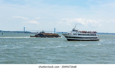 New York, June 30, 2014 - New York Harbor - Barge Filled With Scrap Metal Sailing on the East River.