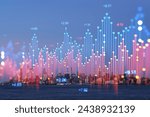 New York Manhattan skyline with a holographic overlay of stock market data, evening lighting, and water in the foreground. Concept of urban technology and business. Double exposure