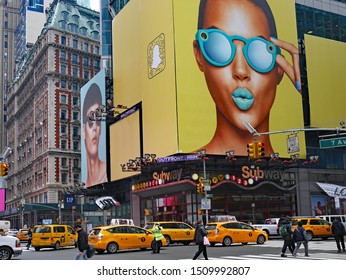 NEW YORK - MARCH 2017:  The Busy Intersetcion Of  7th Avenue At 42nd Street, Near Times Square, Large Billboards, And Traffic On The Street Outside 42nd Street Subway Station.