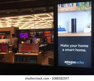 NEW YORK- MAY 2018: Black Amazon Echo , Alexa Voice Service Activated Recognition System Advertised Outside Amazon Book Store. E-commerce Biz Sells Kindles, Fire TV Tablet Alexa Echo AMZN Smart Home