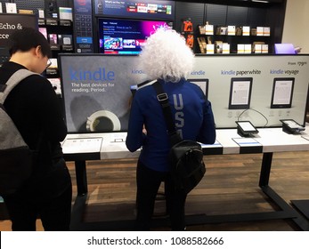 NEW YORK- MAY 2018: Customers Look At Amazon Kindle Family, Kindle Oasis, Paperwhite, Voyage  Inside Amazon Book Store. E-commerce Biz Sells Fire TV Tablet Alexa Echo AMZN