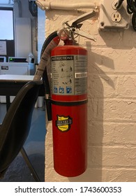 New York, New York - May 2020: Resident Takes Picture Of Fire Extinguisher In Coop Apartment Basement