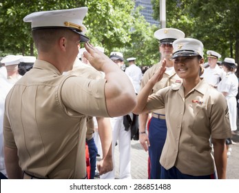 NEW YORK - MAY 22 2015: A US Marine Corpsman Receives A Salute From A Fellow Marine After The Promotion Ceremony At The National September 11 Memorial Site During Fleet Week 2015.