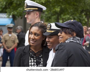 NEW YORK - MAY 22 2015: A Newly Promoted US Navy Officer Poses For A Photograph With Family After The Promotion Ceremony At The National September 11 Memorial Site During Fleet Week 2015.