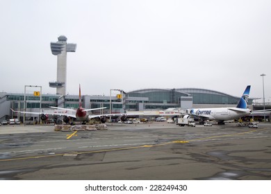 NEW YORK - MAY 8: Air Traffic Control Tower And Terminal 4 With Virgin Atlantic  And EgyptAir Planes At The Gates In JFK Airport In NY On May 8, 2014 