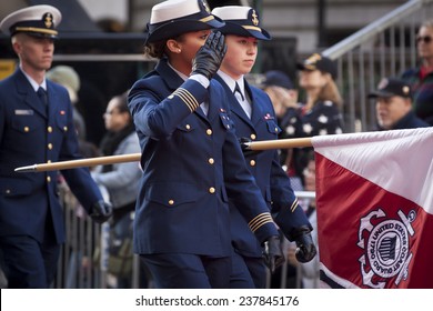 NEW YORK - NOV 11, 2014: A female captain from the US Navy salutes as she marches past the VIP stage during the 2014 America's Parade held on Veterans Day in New York City on November 11, 2014.