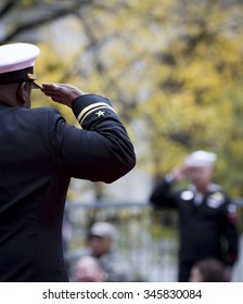 NEW YORK - NOV 25 2015: A U.S. Navy Officer On A Parade Float Salutes A Sailor In The Stands During The Annual Americas Parade Up 5th Avenue On Veterans Day In Manhattan.