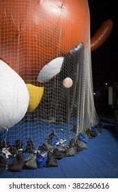 NEW YORK - NOV 25 2015: Red, A Character From Angry Birds Balloon Tied Down With Sandbags And Netting During Macy's Giant Balloon Inflation Event Held The Day Before Thanksgiving In Manhattan.