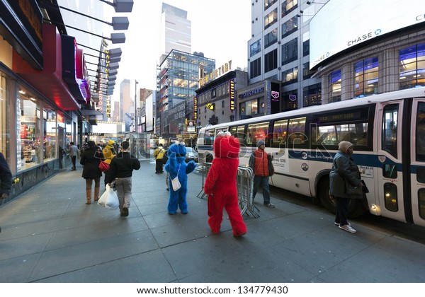 NEW YORK - NOV 6: Two actors hidden in Elmo and\
Cookie Monster costumes amuse the pedestrian walking by at 42nd\
street, just by Times Square in Manhattan  on November 6 2012 in\
New York, New York.