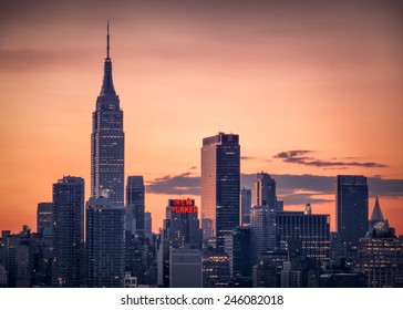 NEW YORK - NOVEMBER 29, 2014 : Sunrise Over Manhattan Skylyne With New Yorker Sign Lit Up.