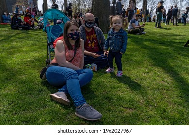 NEW YORK, NY - APRIL 24: Alice, Age 2, With Her Parents Attend An Earth Day Celebration In Astoria Park On April 24, 2021 In The Astoria Neighborhood Of The Queens Borough Of New York City.