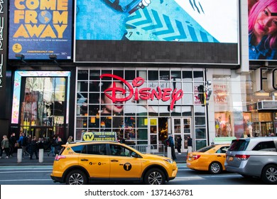 New York, NY - April 3, 2019: This Disney Store Is Located In Manhattan In Times Square In The Heart If The Big Apple. It Is Seen Today With With Taxis On Busy Broadway In Front Of The Store