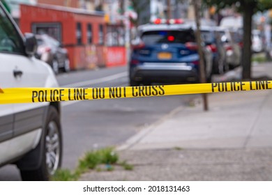NEW YORK, NY – AUGUST 01, 2021: New York Police Department (NYPD) investigate following a gang-related nighttime shooting that injured 10 people on 37 Avenue in Corona, Queens.