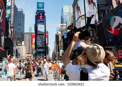 New York, NY: August 28, 2016: A Documentary Film Maker In The Times Square Area Takes Video.   On An Average Day, 360,000 People Visit Times Square.