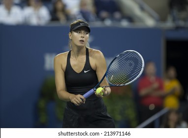 NEW YORK, NY - AUGUST 29, 2014: Maria Sharapova of Russia returns ball during 2nd round match against Sabine Lisicki of Germany at US Open tennis tournament in Flushing Meadows USTA Tennis Center