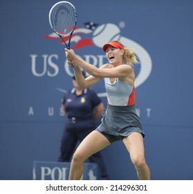 NEW YORK, NY - AUGUST 31, 2014: Maria Sharapova of Russia returns ball during 4th round match against Caroline Wozniacki of Denmark at US Open tennis tournament in Flushing Meadows USTA Tennis Center