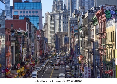 New York, NY - December 12, 2021: Elevated view of old brick buildings and busy streets along East Broadway in Chinatown, NYC, with Lower Manhattan skyscrapers in the background