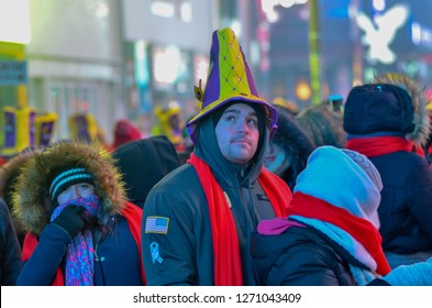 New York, NY. December 31, 2017:  Man Seen Looking At The Clock For Times Square Ball Drop During New Year's Eve Celebrations In Times Square On December 31, 2017 In New York.