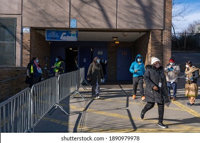 NEW YORK, NY – JANUARY 10, 2021: People That Received The COVID-19 Vaccine Exit The NYC Health Department Vaccine Hub At Hillcrest High School In Queens