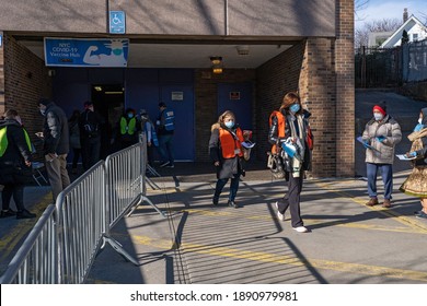 NEW YORK, NY – JANUARY 10, 2021: People That Received The COVID-19 Vaccine Exit The NYC Health Department Vaccine Hub At Hillcrest High School In Queens