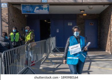 NEW YORK, NY – JANUARY 10, 2021: A Vaccine Hub Worker Wears A Sign Saying “I Speak Spanish” Outside The NYC Health Department Vaccine Hub At Hillcrest High School In Queens